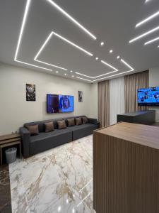 a living room with a couch and a flat screen tv at Zayed Plaza-زايد بلازا in Cairo