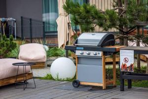 a grill sitting on a table next to a table at For new-style always in Palanga