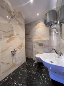 a bathroom with a sink and a toilet at Zayed Plaza-زايد بلازا in Cairo +77 photos
