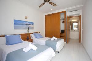 a hotel room with two beds and a bathroom at Apartamento Estándar 3 in Colonia Sant Jordi