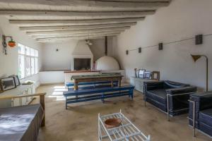 a living room with blue benches and a table at Casa Bernardina in Tilcara
