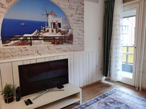 a living room with a large flat screen tv at Deak Ferenc ter Central Apartment in Budapest