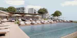 an image of a swimming pool with chairs and umbrellas at Cavo Marelia in Amoopi