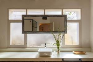 a mirror on a window above a bathroom sink at Casa Bernardina in Tilcara +37 photos