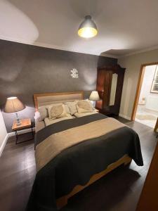 a bedroom with a large bed in a room at Ferienwohnungen Eifelstuben mit Charme - am See, nahe Burg in Ulmen
