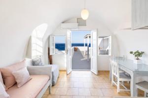 a living room with a couch and a table at Vrachia Studios & Apartments in Oia
