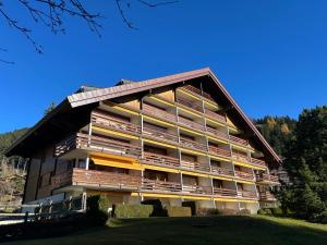 a large building with balconies on the side of it at Central flat in Villars sur Ollon, Amethyste, for 4, with two double beds, balcony and 75m to ski-train in Villars-sur-Ollon