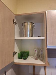 a cupboard with jars and a pot on top of it at Seaput Homes in Ayer Itam +13 photos