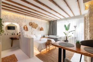 a bedroom with a bed and a desk in a room at Marabou Unique Stay in Thessaloniki