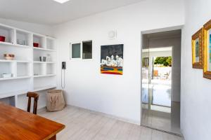 a dining room with white walls and a table at Casa Marina in Costa Teguise