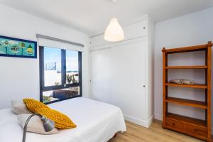a bedroom with a bed and a window at Casa Marina in Costa Teguise