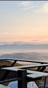 a picnic table on top of a mountain with the sky at ดอยสะโง้วิวโฮมสเตย์บ้านหลังใหญ่ in Ban Doi Sa-Ngo Bon