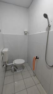 a bathroom with a toilet and a shower at Homestay Atok Mus'lim Only in Jenjarum +5 photos