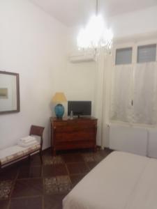 a bedroom with a bed and a desk and a television at Piacenza centro in Piacenza