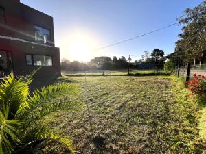 a fence in a field next to a building at Alquiler Mar del Plata Casa en Acantilados in Mar del Plata