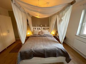 a bedroom with a large bed with a canopy at Weser-City-Panorama 2Zi 9OG 5P Mitte in Bremerhaven