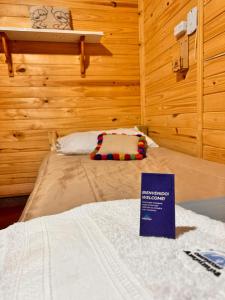 a room with a bed with a sign on it at Observatorio Ampimpa in Amaicha del Valle +15 photos