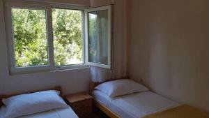 Postel nebo postele na pokoji v ubytování Apartments Jope