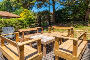 a wooden picnic table and two chairs on a deck at Departamentos NIZA 313 in Ostende