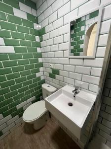 a bathroom with a white toilet and a sink at Zona Camp Nou 15 minutos centro en metro in Hospitalet de Llobregat +25 photos