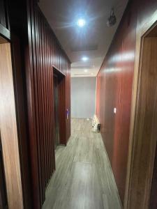 an empty hallway with wood paneled walls and a room at BBimmo APPART HOTEL in Dakar +1 photo