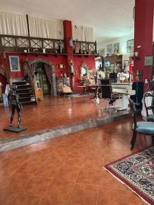 a living room with red walls and a statue in the middle at Castillo Lanzarote Villa Antonia in Tías +52 photos