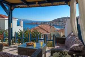 a patio with a table and a view of the water at Yellow Oasis traditional home with sea view in Halki