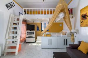 a room with two bunk beds and a couch at Yellow Oasis traditional home with sea view in Halki