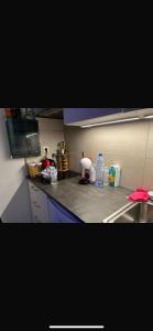 a kitchen counter with bottles of water on it at Appartement Donatella in Liège