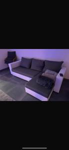 a living room with a couch and a keyboard at Appartement Donatella in Liège