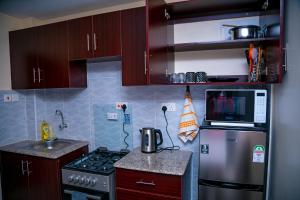 Kuchyň nebo kuchyňský kout v ubytování Dreamy Abode 1BR Kisumu