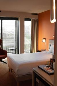 a hotel room with a bed and a large window at Radisson Blu Hotel Bordeaux in Bordeaux