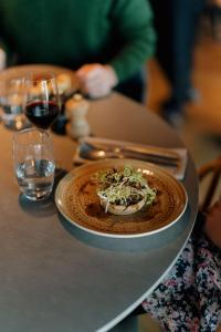 a plate of food on a table with wine glasses at Radisson Blu Hotel Bordeaux in Bordeaux