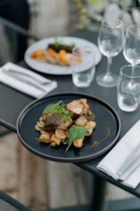 a plate of food on a table with wine glasses at Radisson Blu Hotel Bordeaux in Bordeaux
