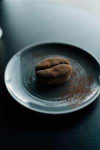 a cookie sitting on a plate on a table at Radisson Blu Hotel Bordeaux in Bordeaux