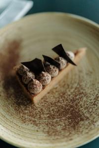 a piece of pizza sitting on a plate at Radisson Blu Hotel Bordeaux in Bordeaux