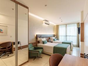 Cama ou camas em um quarto em Athos Bulcão Hplus Executive