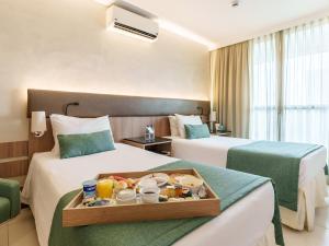 Cama ou camas em um quarto em Athos Bulcão Hplus Executive