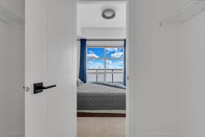 a bedroom with a bed and a window at Bright Condo with Balcony & Free Parking in Calgary
