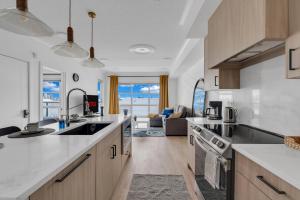a kitchen with a view of the ocean at Bright Condo with Balcony & Free Parking in Calgary