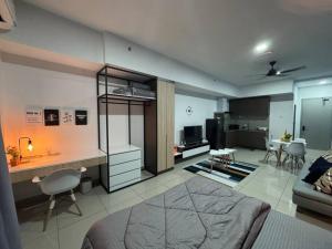 a bedroom and living room with a bed and a kitchen at Alinea Suites Seksyen 14 in Shah Alam