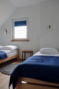 Postel nebo postele na pokoji v ubytování Domki Ostoja Kaszëbë