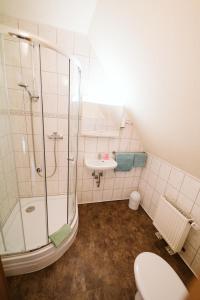 a bathroom with a shower and a toilet and a sink at Landgasthof Schlotmann in Welver