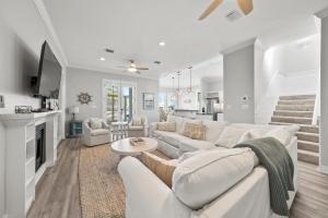 a living room with a white couch and a fireplace at Ventana Breeze in Santa Rosa Beach