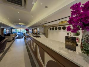 a bar in a train station with purple flowers at Quality Gold Suite Hotel in Antalya +104 photos