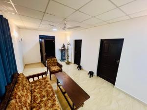 a living room with a couch and two chairs and a table at Lagoon House - Hiriketiya in Dickwella