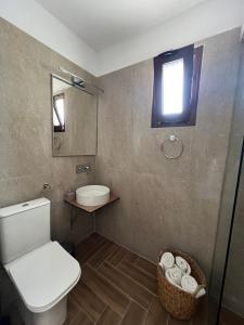 a bathroom with a toilet and a sink and a window at Cactus in Skiathos Town +24 photos
