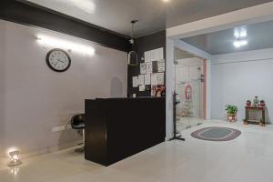 a room with a counter and a clock on the wall at Super Townhouse Vidya Vihar in Patna +53 photos