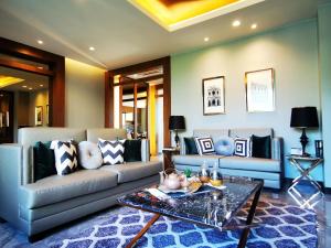 a living room with a couch and a table at Luxury Two bedroom private swimming pool townhouse , Walk 800 meters to Kamala Beach in Phuket Town