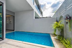 a swimming pool in the backyard of a house at Luxury Two bedroom private swimming pool townhouse , Walk 800 meters to Kamala Beach in Phuket Town